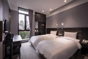 Postel nebo postele na pokoji v ubytování Yi Su Hotel-Taipei Ningxia