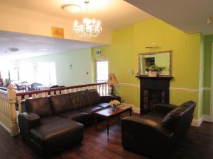 a living room with a couch and a fireplace at The Beaumont Accommodation in Louth
