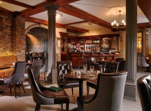 a restaurant with tables and chairs and a bar at Citywest Hotel in Citywest