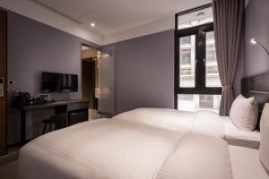 Postel nebo postele na pokoji v ubytování Yi Su Hotel-Taipei Ningxia