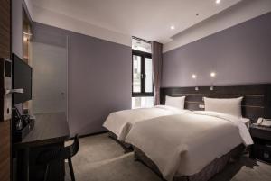 Postel nebo postele na pokoji v ubytování Yi Su Hotel-Taipei Ningxia