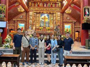 a group of people standing in front of a church at Fish Farm Homestay in Yên Bái