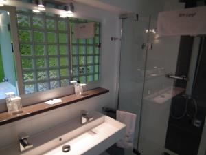 a bathroom with a sink and a shower and a mirror at Holiday Home New Largo in Nieuwpoort +47 photos