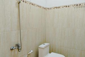 a bathroom with a toilet and a shower at RedDoorz at Trans Hotel Cilegon in Toyamarta