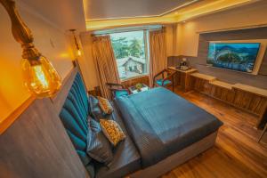 a living room with a couch and a window at Singhs BnB by Lazy Getaways in Shimla +39 photos