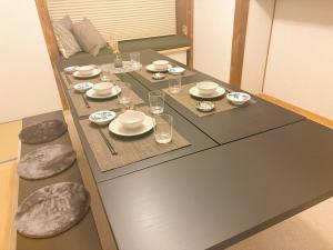 a table with plates and glasses on top of it at Casa Arita in Zōshuku +11 photos