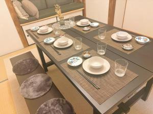 a dining room table with plates and dishes on it at Casa Arita in Zōshuku