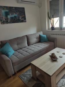 a living room with a couch and a coffee table at Apartman MD in Lukavica