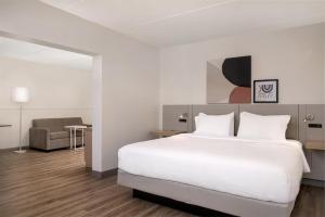 a hotel room with a bed and a chair at Spark by Hilton Fishkill in Fishkill +39 photos