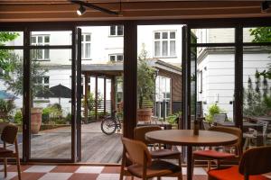 a restaurant with a patio with tables and chairs at Hotel Mayfair in Copenhagen