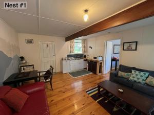 a living room with a couch and a table at Grampians Nest in Halls Gap