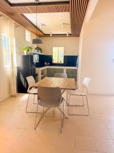 a dining room table and chairs in a kitchen at Lakaz Riviere Banane in Trèfles
