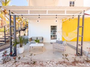 a patio with two benches and a table at Lakaz Riviere Banane in Trèfles