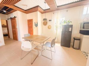 a dining room with a wooden table and chairs at Lakaz Riviere Banane in Trèfles +16 photos