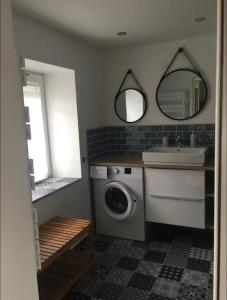 a bathroom with a washing machine and a sink at La Bulle d Avenir in Corcieux +40 photos