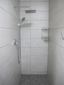 a shower with a glass door in a bathroom at Sunrise Cottage in Wilderness +11 photos