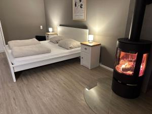 a bedroom with a bed and a fire place at Ferienwohnung auf dem Land in Grethem