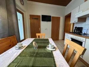 a kitchen with a table with two cups on it at Mariazellerhof Suite 016 in Sankt Pölten