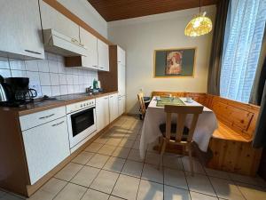 a kitchen with a table and a kitchen with white cabinets at Mariazellerhof Suite 016 in Sankt Pölten