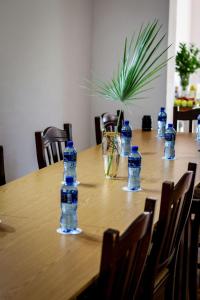 a wooden table with bottles of water on it at Palm La Vie in Worcester +61 photos