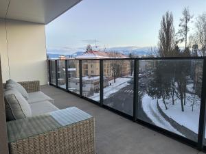 a balcony with a couch and a view of a city at Apartmán FILIP v centre Žiliny in Žilina