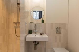 a bathroom with a sink and a toilet and a mirror at Cosy studio - 2P - Bellecour in Lyon