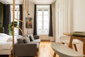 a living room with a couch and a table at Cosy studio - 2P - Bellecour in Lyon