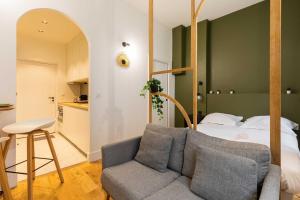 a living room with a couch and a bed at Cosy studio - 2P - Bellecour in Lyon