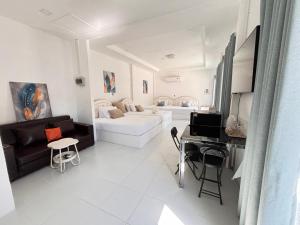 a white living room with a bed and a desk at ชิลชิลขนอมพูลวิลลา in Ban Thong Ching +13 photos