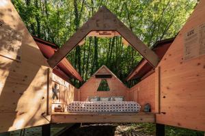a bedroom in a tree house in the woods at StarsBox CasaSilvana in Alba