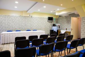 a room with chairs and a table and a podium at Hotel Millennium in Osijek