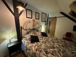 a bedroom with a large bed with a wooden headboard at Chambre Coco in Bressuire