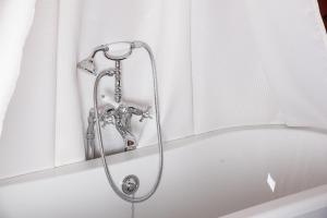 a shower in a bath tub with a shower head at Chambre Coco in Bressuire