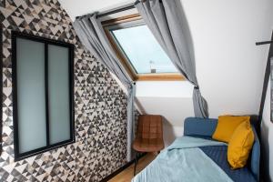 a small bedroom with a window and a bed at Les chambres du Bocage - Chambre Marylin in Bressuire +14 photos