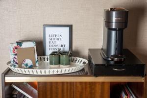 a coffee maker sitting on top of a wooden table at Les chambres du Bocage - Chambre Marylin in Bressuire