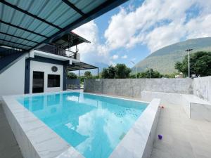 a swimming pool in a house with a mountain in the background at Yankoi Mountains view in Chiang Dao