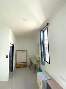 a room with a table and a window at Lantara resort in Ko Lanta