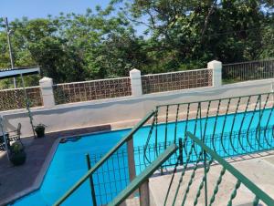 a swimming pool with a fence around it at Nkosazana Guest House in Durban