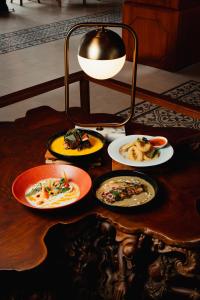 a table with plates of food on top of it at Acasa Cottage by Samsara in Cipaok +57 photos