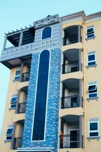 a tall apartment building with a large window at Eternal shine serenity in Munyonyo