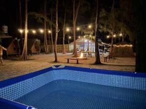 a swimming pool in front of a tent at night at Mi Familia CAMP in San Felipe