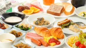 a table filled with plates of different types of food at Hotel Route-Inn Gotenba Eki-Minami in Gotemba +40 photos
