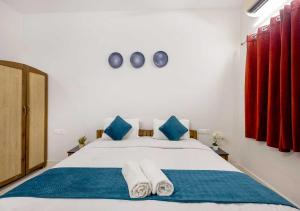 a bedroom with a bed with towels on it at Palette Susegad I 3BHK Apartment I Pool I Candolim I GOA in Candolim +40 photos
