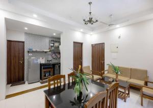 a dining room and living room with a table and chairs at Palette Susegad I 3BHK Apartment I Pool I Candolim I GOA in Candolim