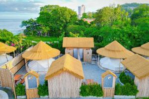 a group of tables and chairs with umbrellas at Bangsaen Villa in Bangsaen