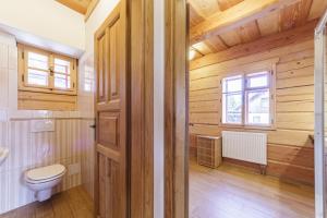 a bathroom with a toilet and a window at Roubenka Nové Hutě in Nové Hutě