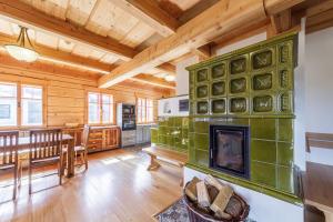 a living room with a fireplace in a log cabin at Roubenka Nové Hutě in Nové Hutě