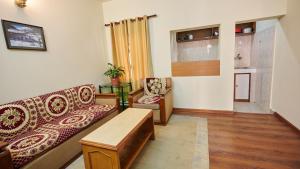 a living room with a couch and a table at Hotel Norbu Sangpo in Kathmandu
