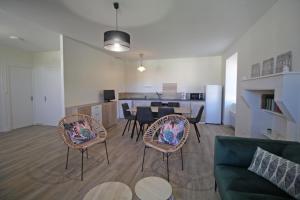 a living room with two babies sitting on chairs and a couch at Gîte 87G7452 in Saint-Mathieu
