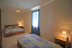 a bedroom with two beds and a window at Gîte 87G7452 in Saint-Mathieu